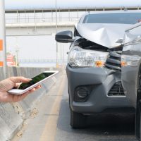 Car crash from car accident on the road in a city car pickup wai A driver calling attorney immediately after car accident.