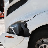 Damage closeup on white truck.