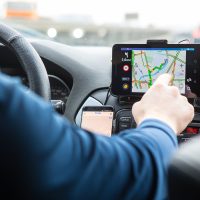 Driver in the car controls the navigator. Close-up part