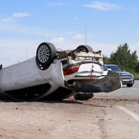 Car accident on the road. The motorist violated the speed limit, did not fit into the turn. The car rolled over, wheels up.