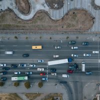 A truck and a car collided on the highway. Serious accident. Traffic accidents on the road. View from above. Traffic jam. Insured event on the road.