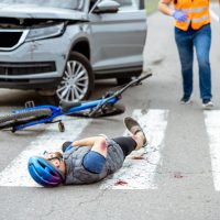 Road accident with injured cyclist and car driver