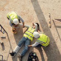 First aid worker accident in construction site, Builder accident fall scaffolding to concrete floor.