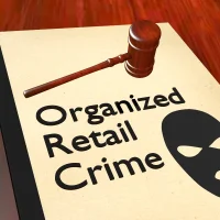 a-gavel-rests-on-a-document-titled-organized-retail-crime-with-a-black-mask-icon