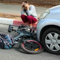 a-woman-in-distress-crouches-on-a-curb