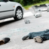 a-gray-car-involved-in-a-crash-with-debris-scattered-on-the-road